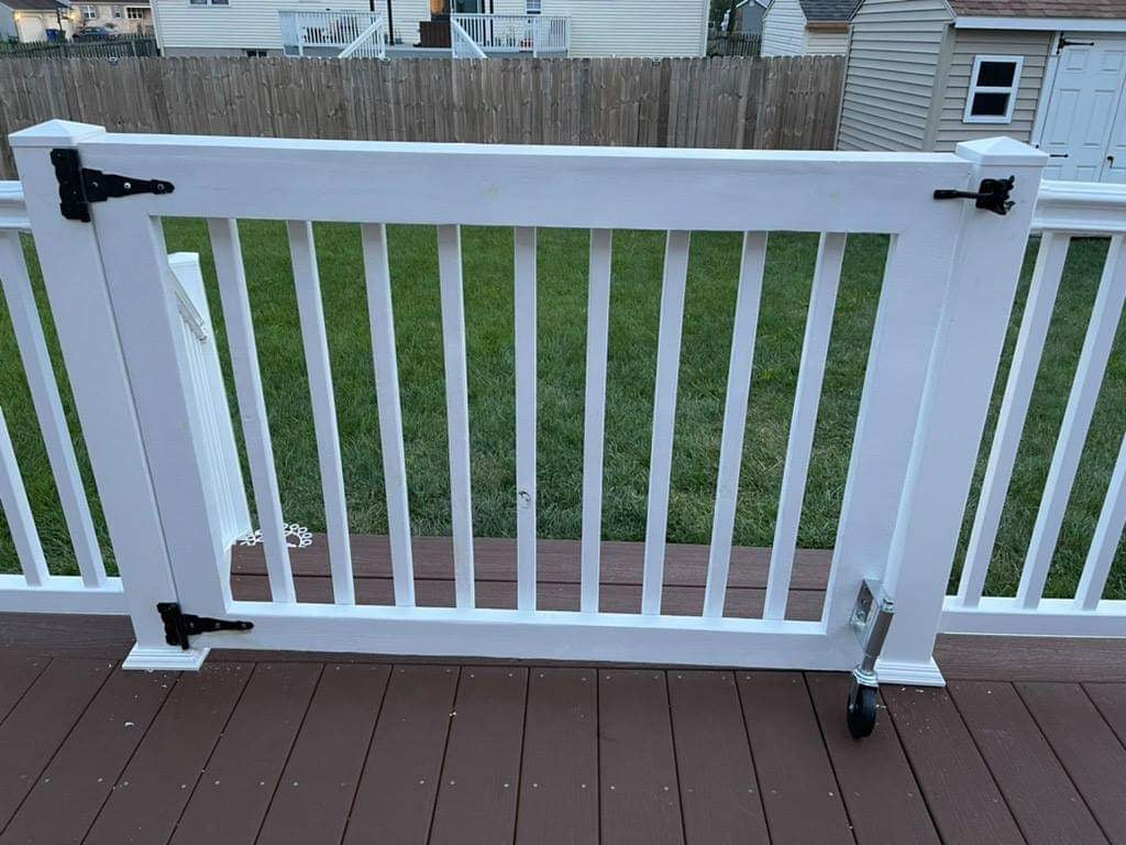 Single baluster gate painted white with support wheel