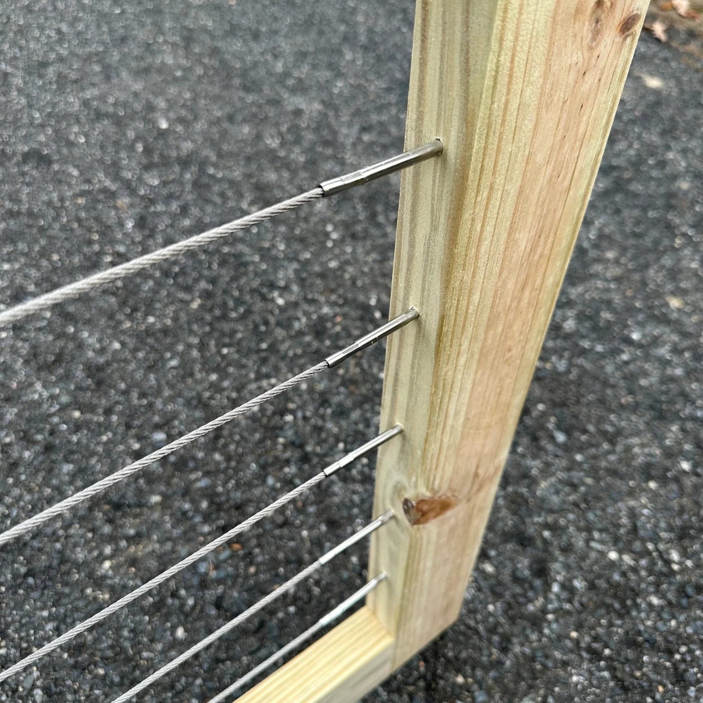 close-up view of the 1/8β T316 stainless steel cable wiring on a modern patio gate, highlighting durability and sleek design.