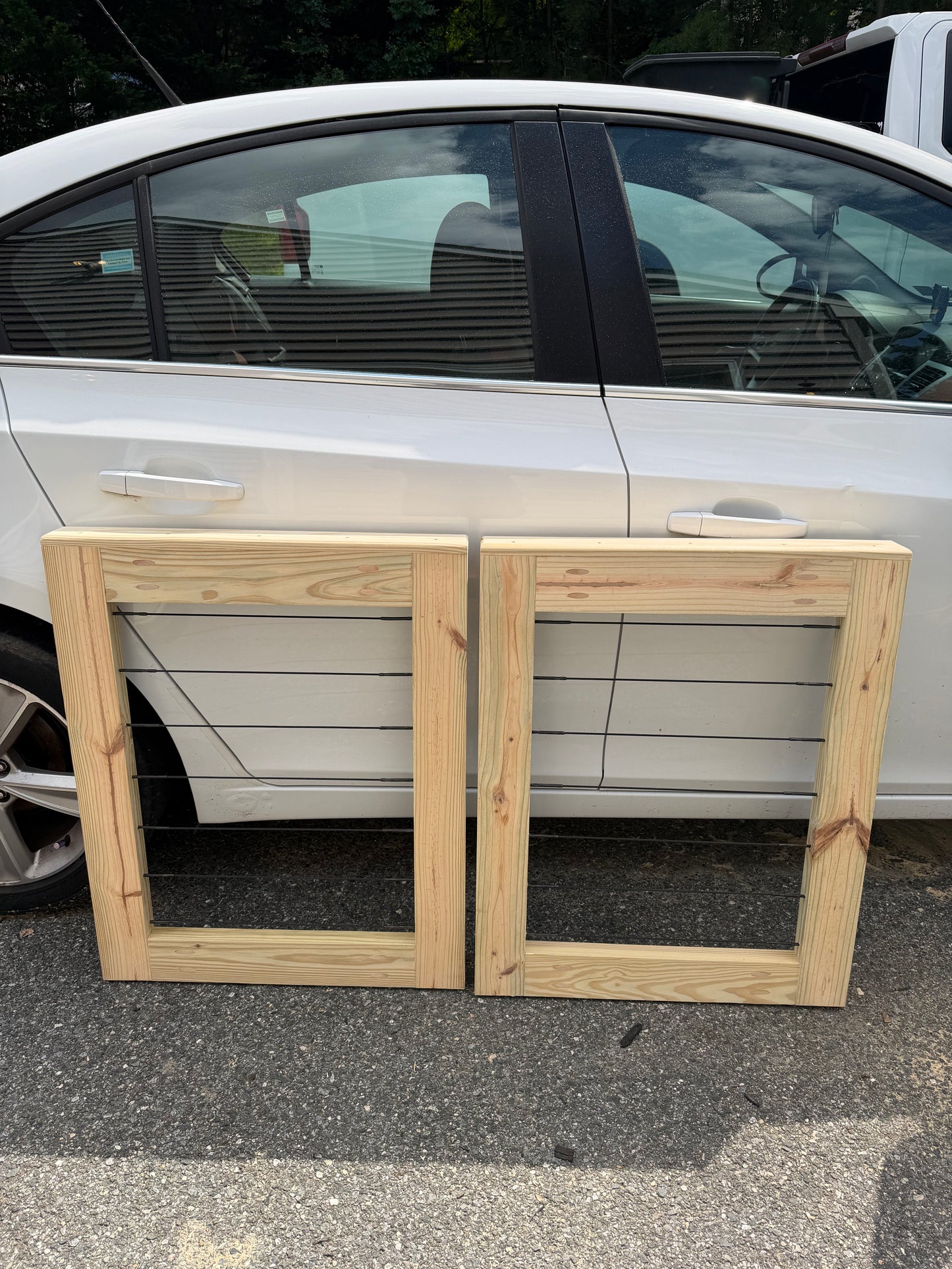 Two custom pressure-treated wood patio gate panels with horizontal cable wire railing