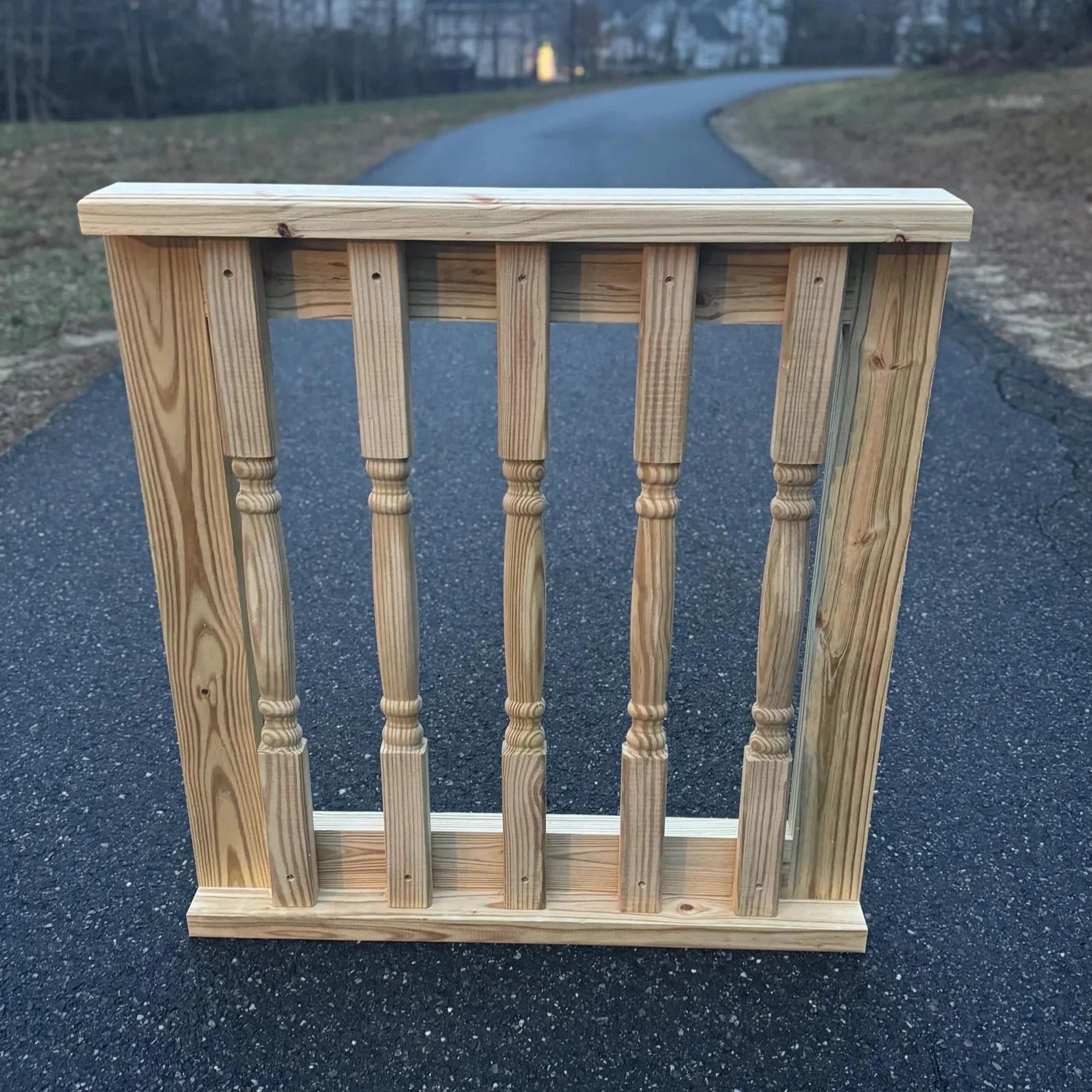 Front view of a handcrafted decorative wooden baluster gate, showcasing intricate baluster design and sturdy wooden frame, ideal for patios and decks.